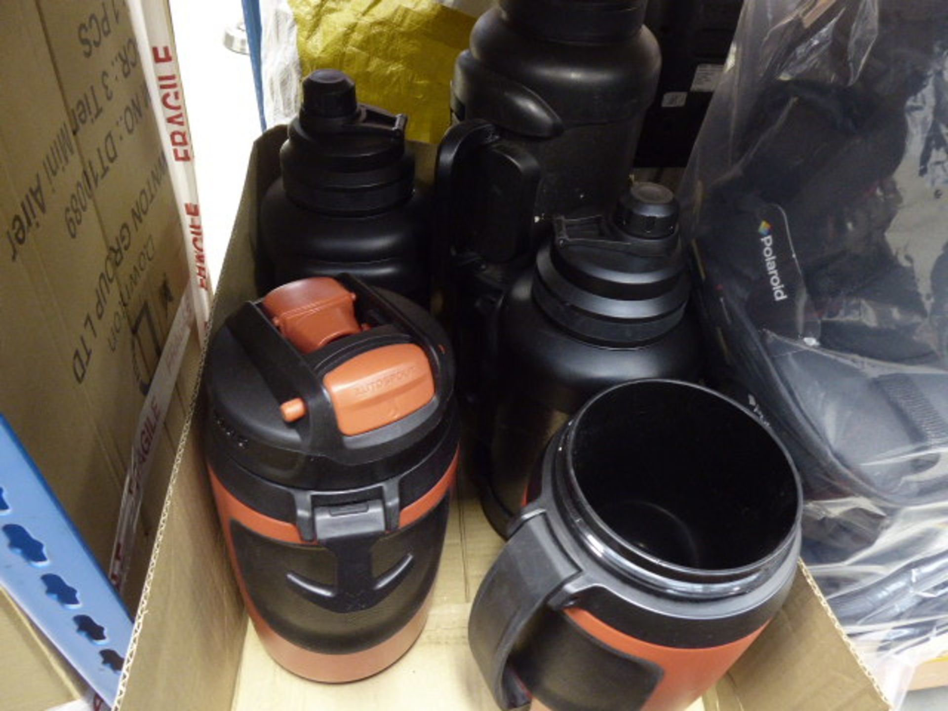 Box containing some large drinking bottles and a flask