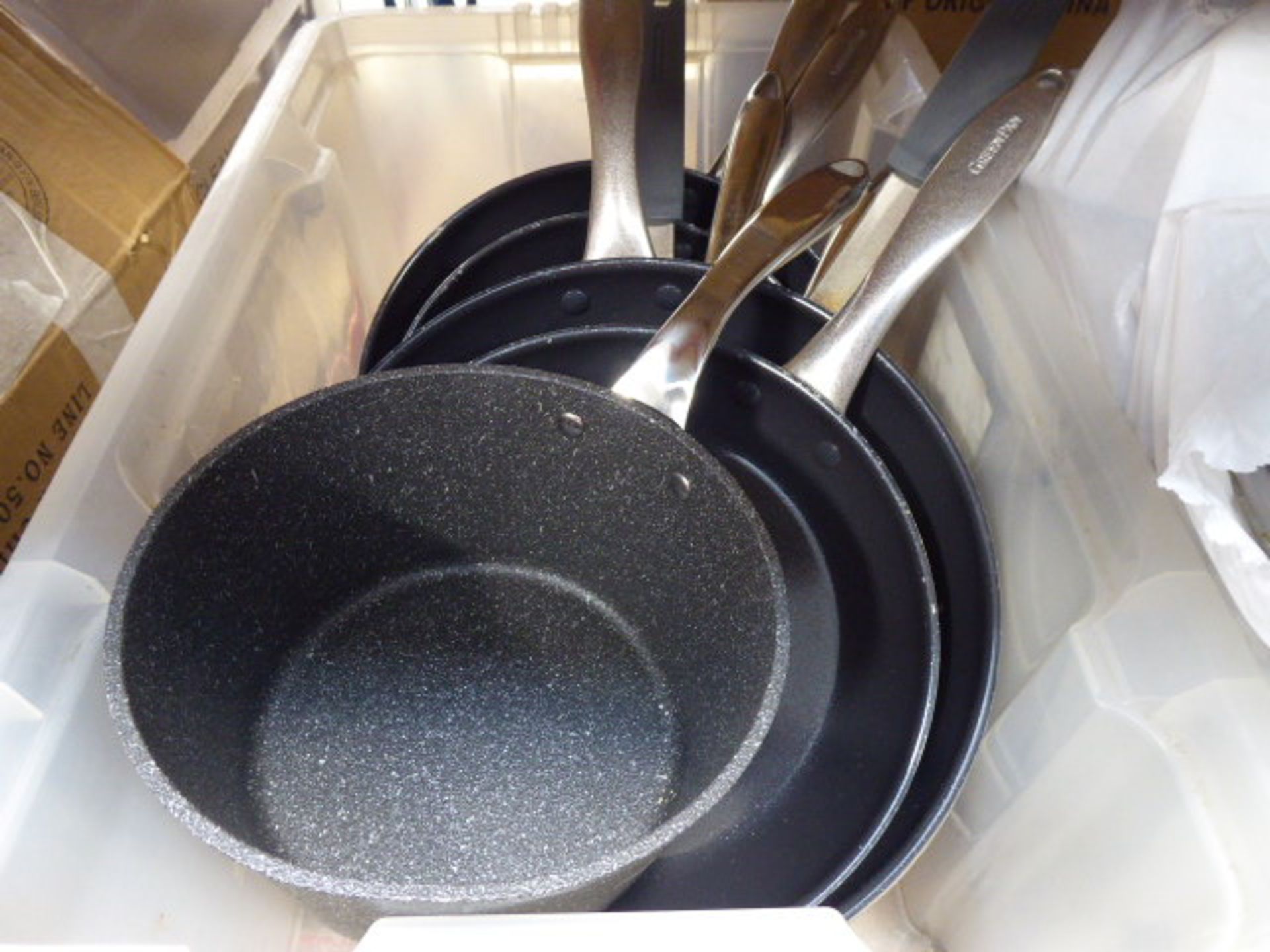 Box of green frying pans and a cooking pot