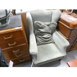 Green fabric wing back armchair with cushion
