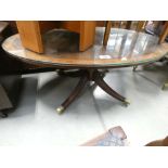 An oval reproduction mahogany coffee table