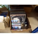 Box containing vinyl records and DVDs