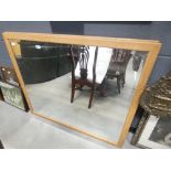 A pair of rectangular bevelled mirrors in oak frames
