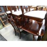 A dark wood extending dining table, plus eight chairs