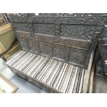 Large heavily carved oak bench