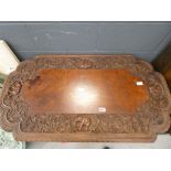 Heavily carved Siamese table with elephant floral and dragon pattern