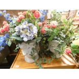 Two flower pots with artificial roses and other flowers