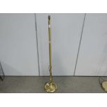 A brass finished floor lamp