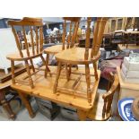 A pine dining table, plus four stick back chairs