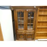 Glazed oak display cabinet with drawers and cupboard under