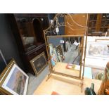 An adjustable table top mirror in wrought iron frame