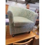 Green and beige floral upholstered tub chair