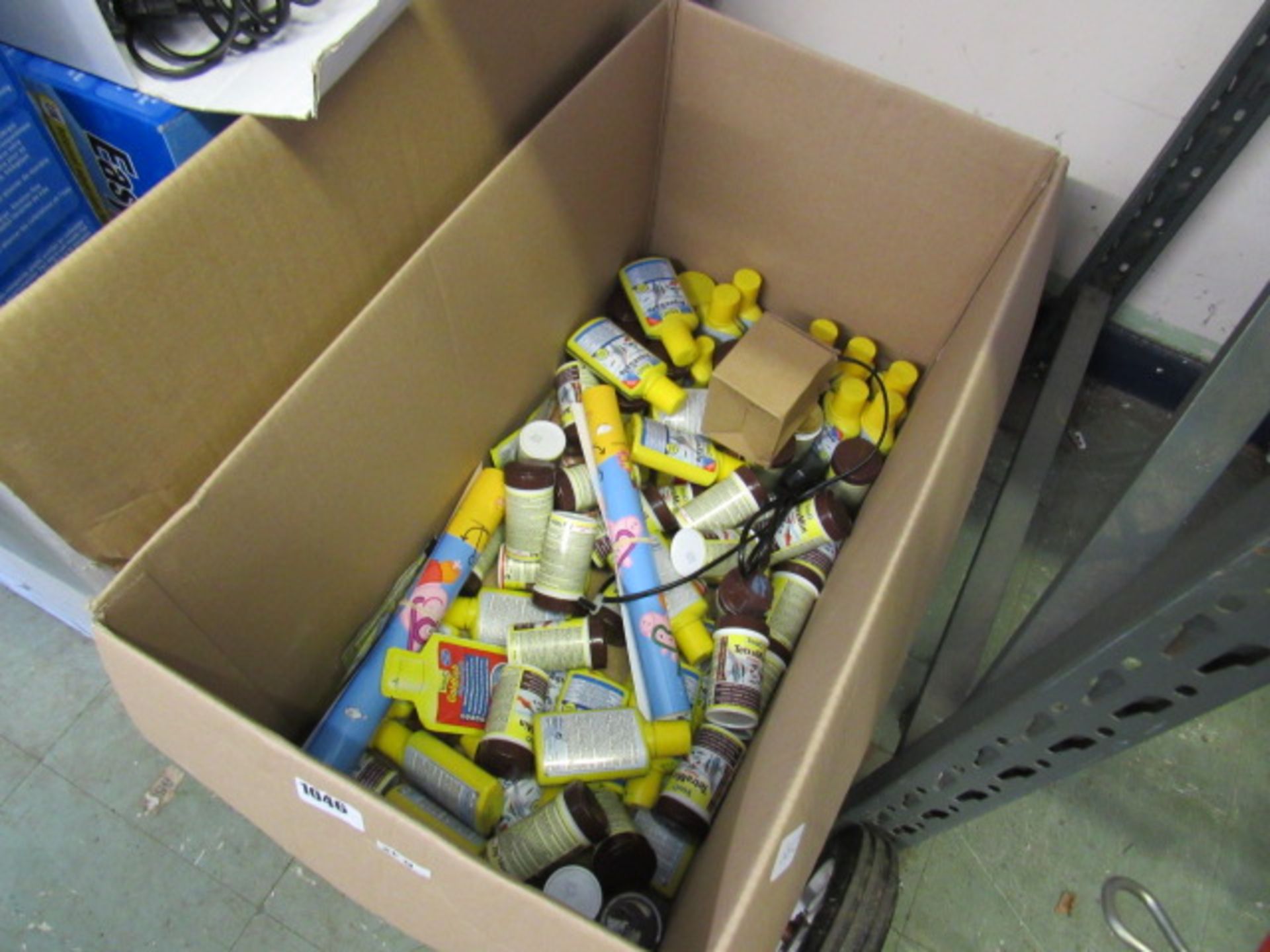 Box containing various Tetra aqua safe chemicals and Tetra fish flakes