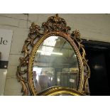 Decorative gilt framed oval wall mirror