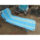 Blue and white striped sun lounger