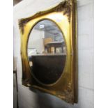 Oval gilt framed and bevelled wall mirror