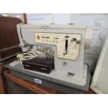 Vintage Singer sewing machine with case and 1 other