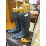 Pair of vintage black riding boots with vintage wooden stretchers