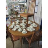 Oak finish circular extending dining table and 4 slat back chairs