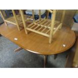 Teak finish oval extending dining table