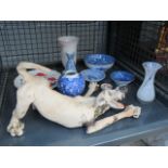 Cage containing blue and white china and an ornamental dog