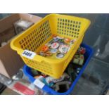 Box containing die cast toy cars and childrens badges