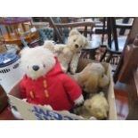 Box containing push along toy dog, paddington bear and other teddy bears