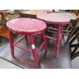 2 red painted elm stools