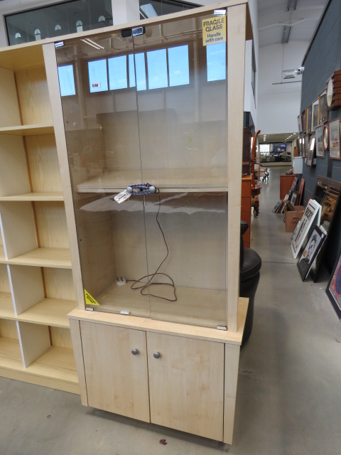 Maple finished display cabinet with glazed doors