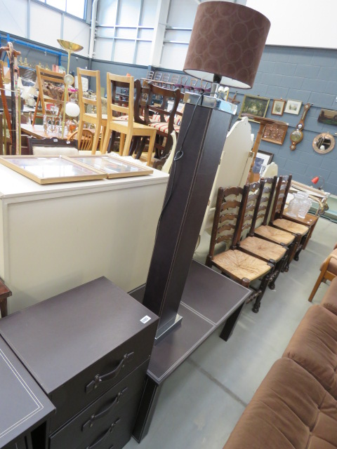 Brown leather clad chest of 4 drawers and a coffee table and floor lamp