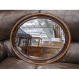 Oval bevelled mirror in walnut frame