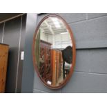 Oval bevelled mirror in oak frame