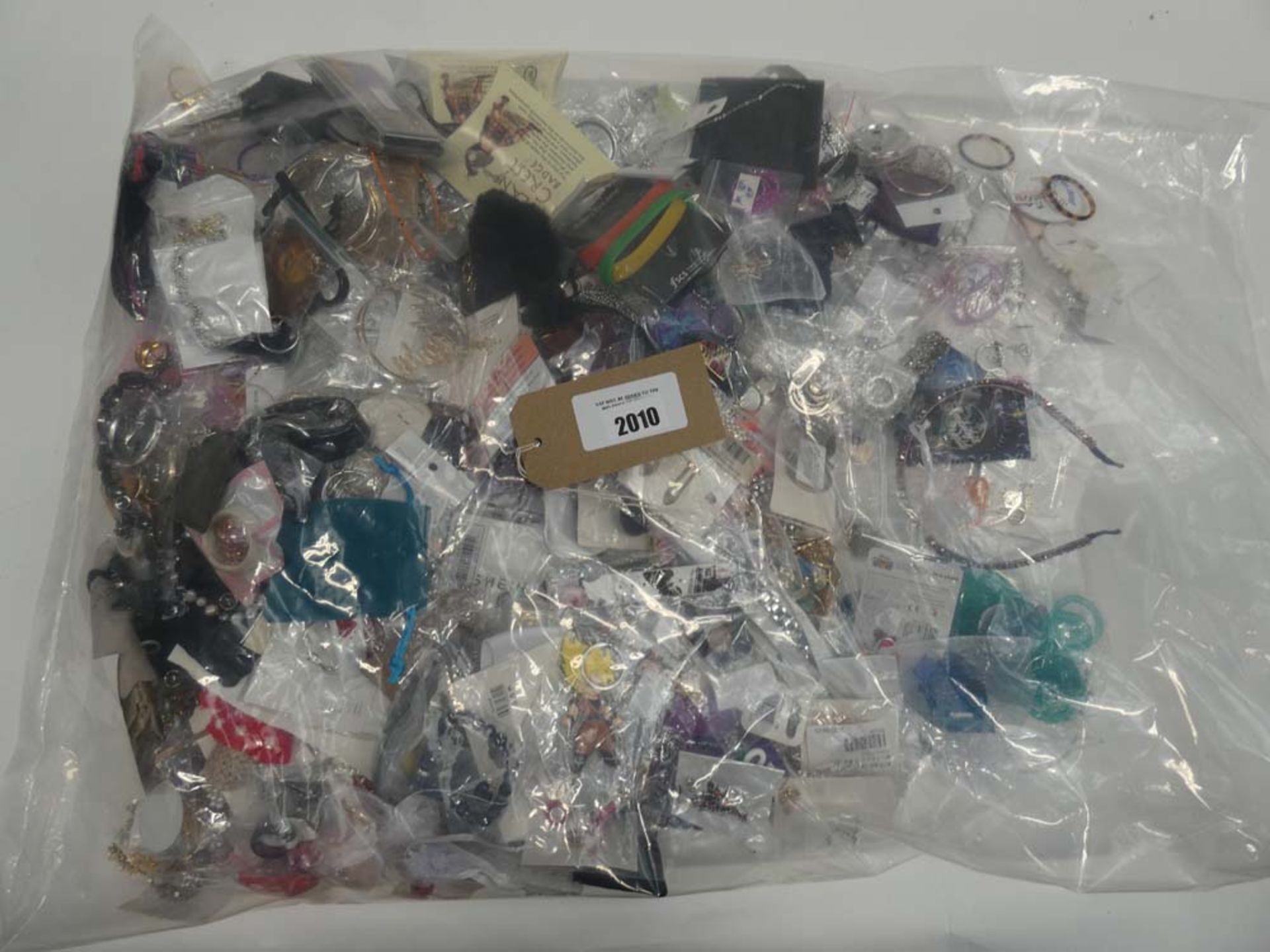 Bag containing quantity of loose costume and dress jewellery