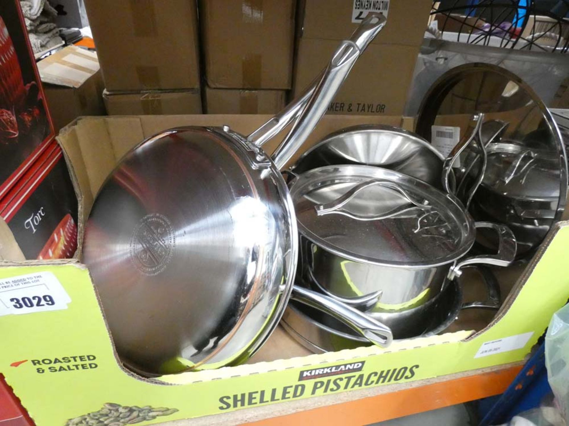 Tray containing stainless steel Kirkland pots and pans