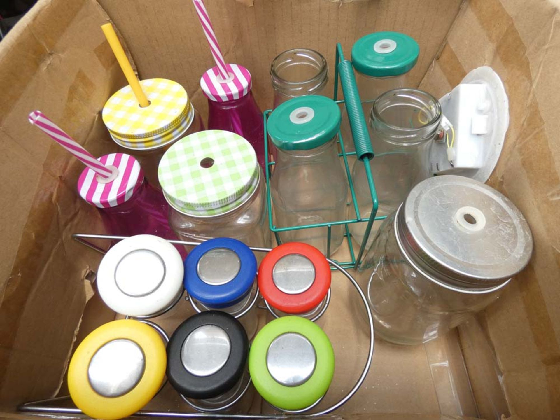 Box containing various sized glass jars