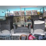 Black rattan patio set comprising 2 armchairs and glass top side table