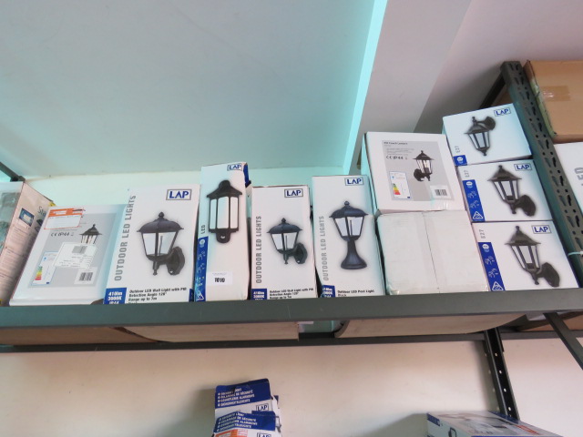 Shelf containing boxed outdoor LED coach lantern wall lights in mixed sizes