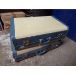 Pair of blue and cream luggage cases