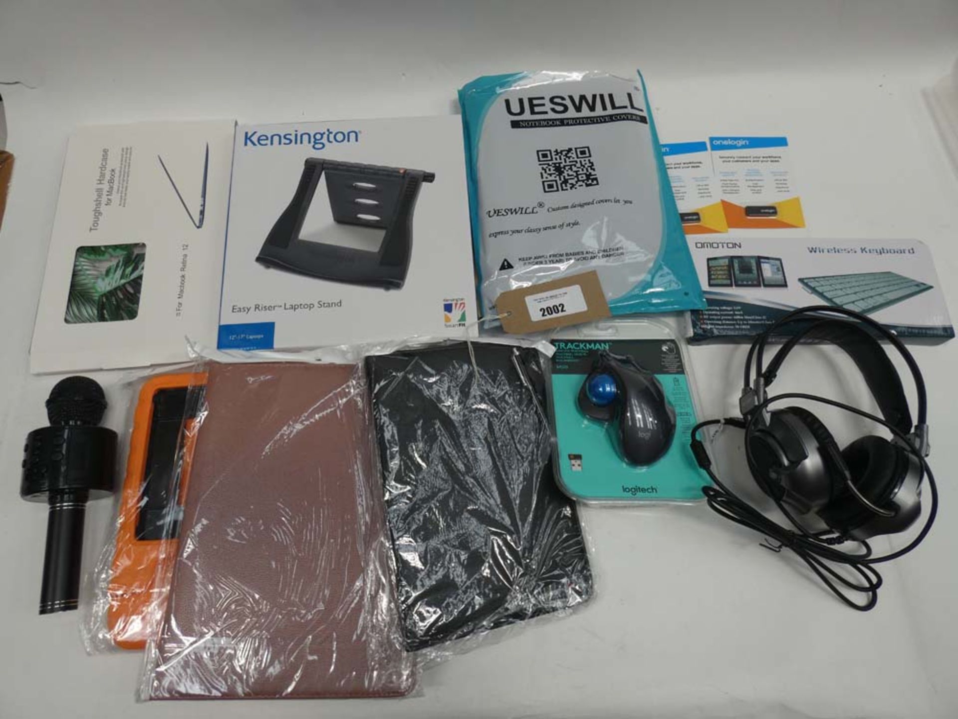 Bag containing tablet cases, microphone, Tecknet headset, Kensington laptop stand, Logitech Trackman