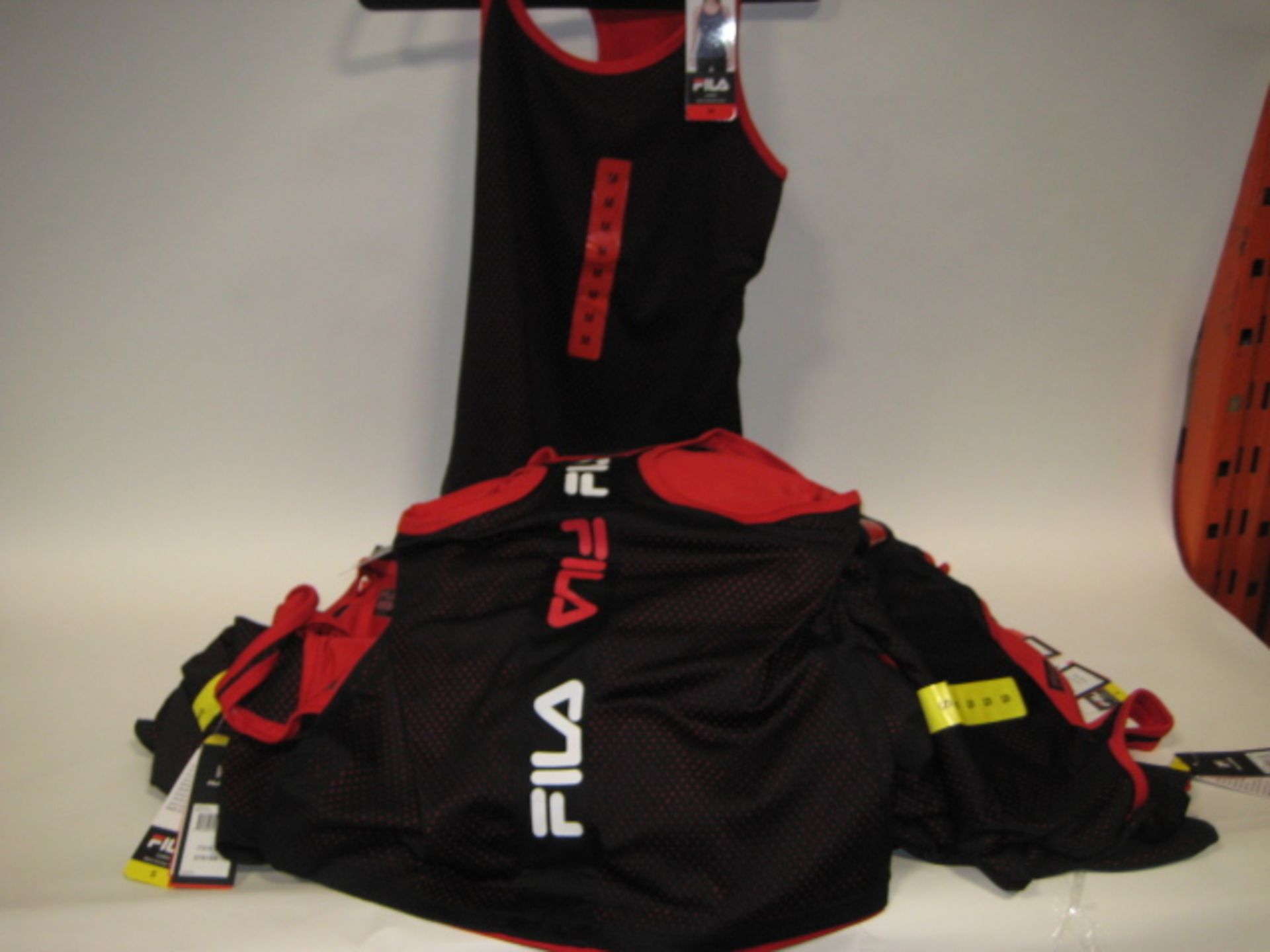 Bag containing 30 ladies Fila mesh overlay tank tops in black and red sizes S & M