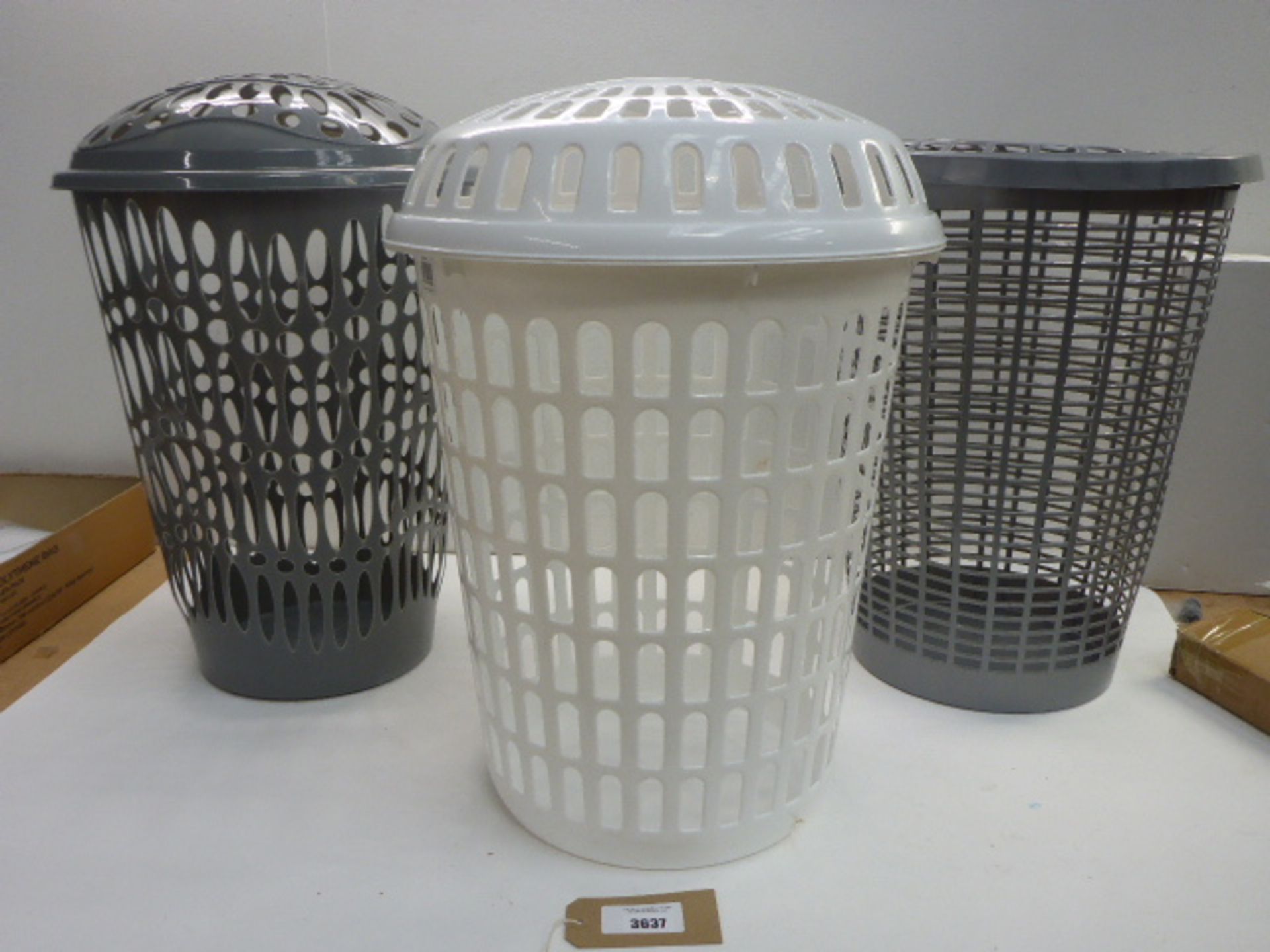 2 grey and 1 white plastic lidded laundry baskets