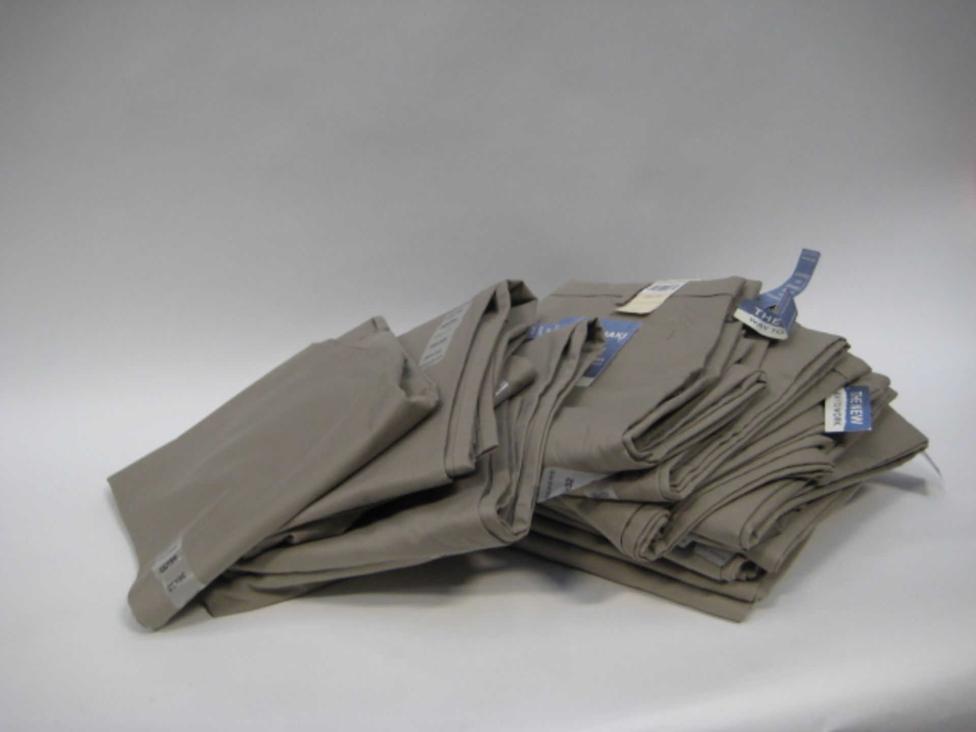 Bag containing 15 pairs of Soccer Khaki gents trousers size ranging from 32'' waist - 40'' waist -