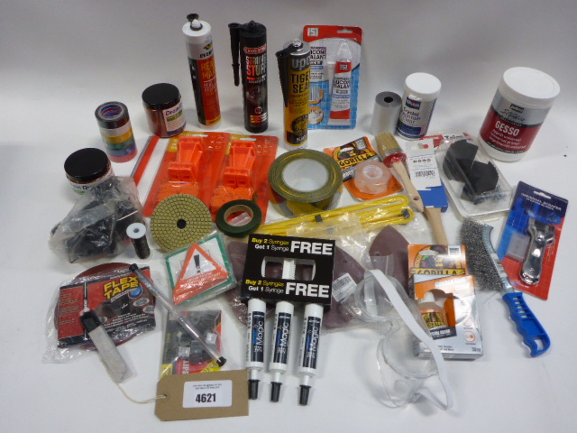 Bag containing string lines, tiger seal, evostick adhesive, silicone sealant, wire brushes, sand