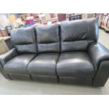 A green leather effect 3 seater reclining sofa