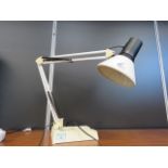A cream painted anglepoise-style desk lamp