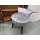 Grey fabric chair with circular seat