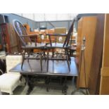 5065 - A dark oak refectory table, plus 4 wheel back chairs