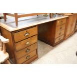 Early 20th Century oak twin pedestal desk with 8 drawers and brown leather effect writing surface