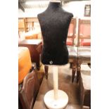 Black dress maker's dummy on white single pedestal base