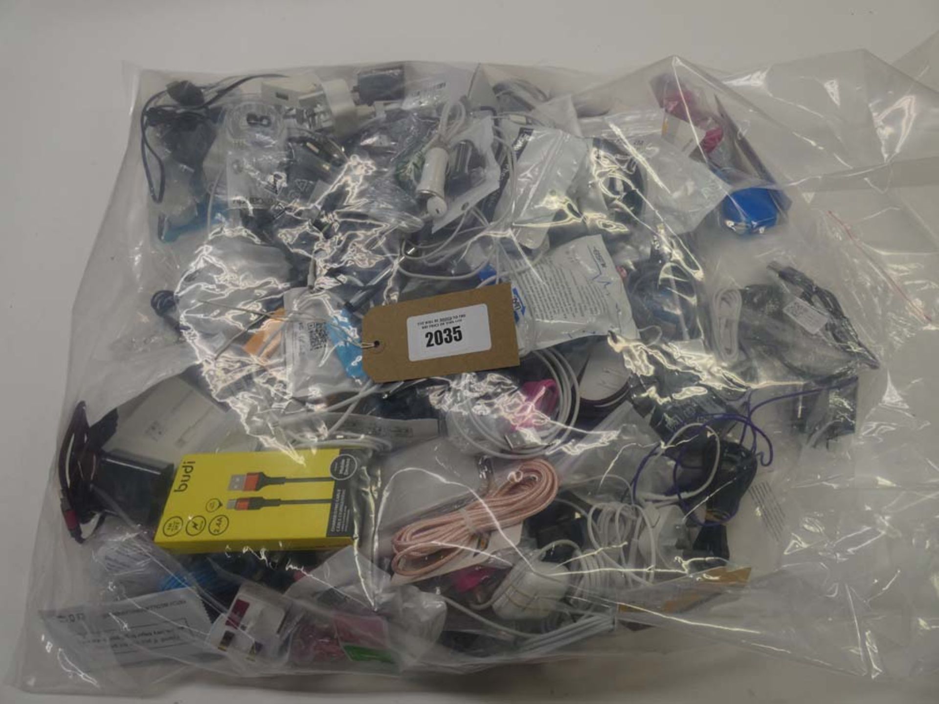 Bag containing quantity of mobile phone accessories; cables, adapters, earphones, lightning cables