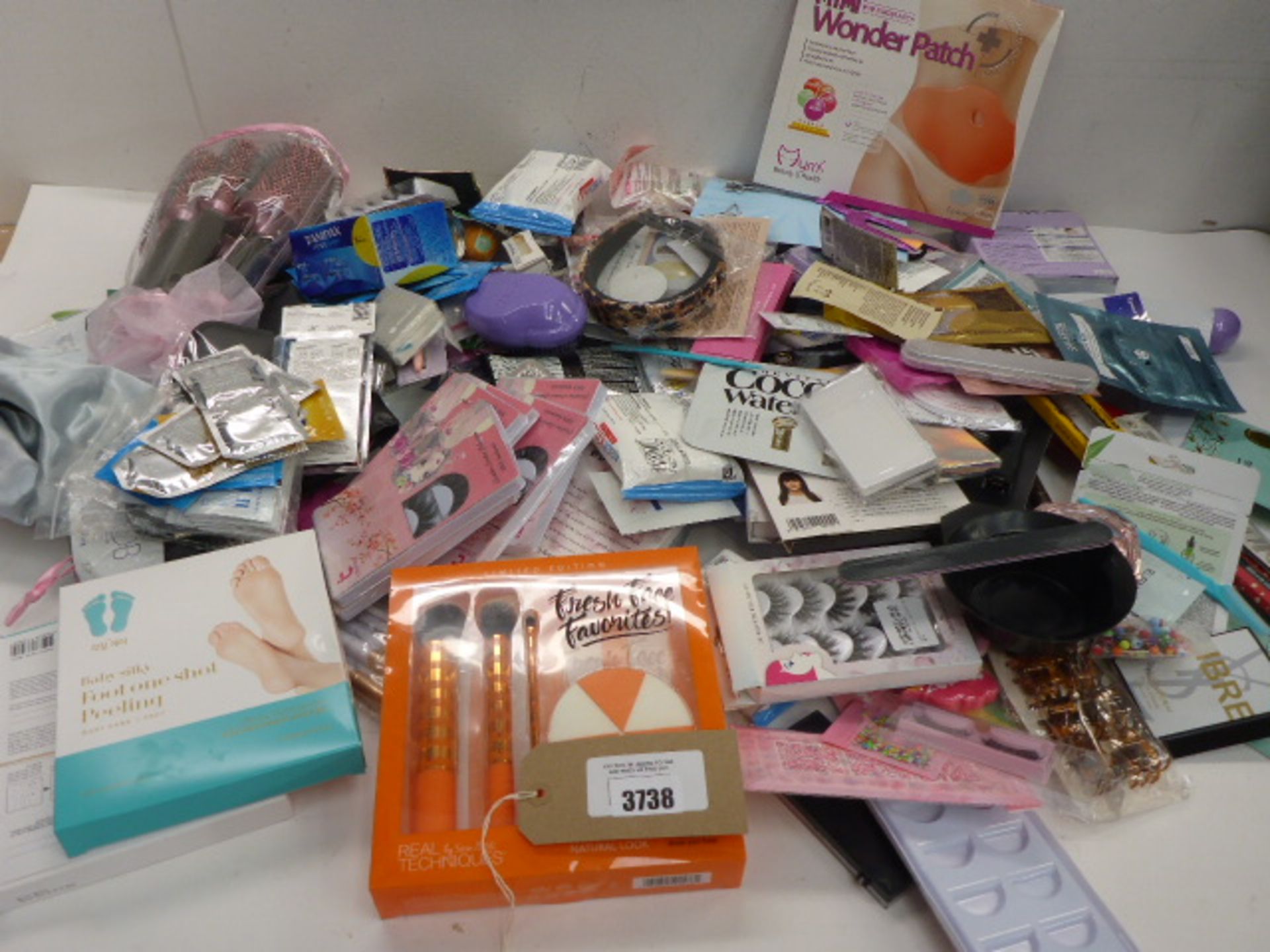 Large bag of beauty products including makeup & hair brushes, perfume & sample sachets, hair